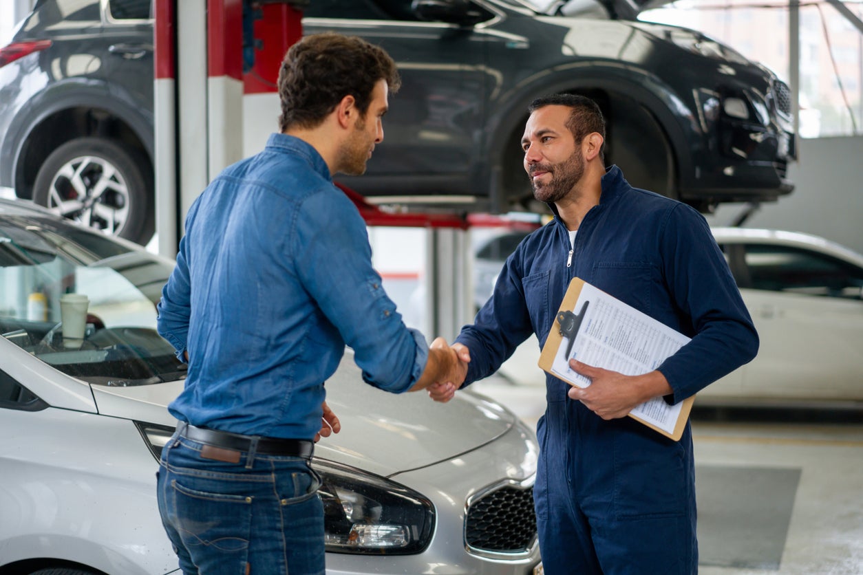Service advisor greeting a customer at the drive lane